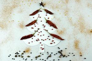 Christmas tree made of dried red pepper, peppercorns and ground photo