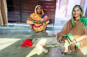 Lucknow, India, October 2021, A rural woman repair traditional spices maker sil batta photo