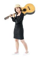 Woman carrying acoustic guitar on shoulder photo