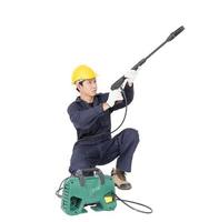 Young man sitting and holding high pressure water gun photo