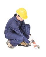 Young handyman in uniform hold grinder photo