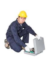 Young handyman sitting with his tool box photo