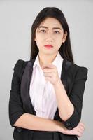 Woman in suit looking at camera and pointing finger photo