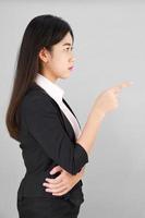 Woman in suit looking at camera and pointing finger photo