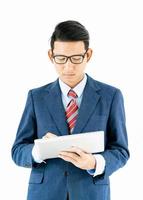 Businessman portrait in suit holding a laptop over white background photo