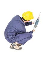 manitas en uniforme sentado con su taladro eléctrico foto