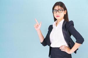 Business woman in suit with finger pointing up photo