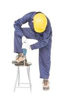 Man in unifrom standing with his electric drill, Cutout isolated on white photo