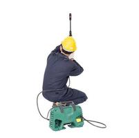 Young man sitting and holding high pressure water gun photo