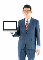 Businessman portrait in suit holding a laptop over white background photo