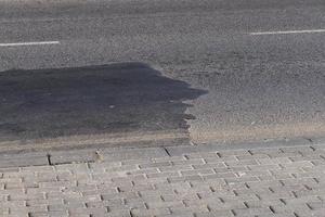 The repaired part of an asphalt road with patches photo