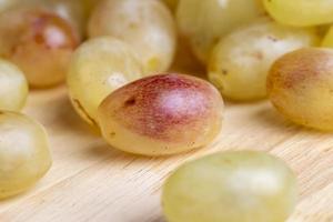 Homemade green unwashed grapes on a board photo