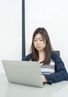 Young female student  sitting in living room and learning online photo