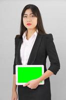 Young women in suit holding her digital tablet mock up photo