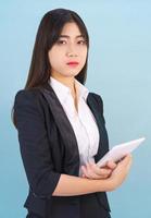 Women standing in suit holding digital tablet photo