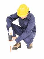 Man hold hammer and cold chisel on white photo