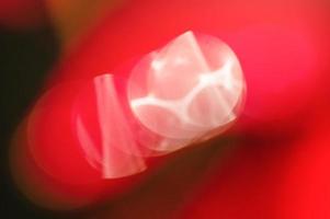 Abstract defocused red background with glare. Defocus light. photo