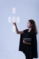 Woman pushing World wide map hologram on virtual screen. Global business and telecommunication technology concept. photo