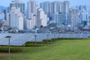 Power plant using renewable solar energy with city building background. photo