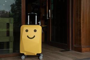 Traveler suitcase with happy face at home. photo