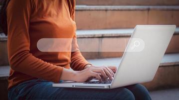 Young woman leaning and using computer searching research information by written in search bar or search box on virtual screen, browsing Internet global data Information, technology learning concept. photo