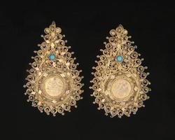 The vintage, central Asian earrings with precious stones isolated on a black background photo