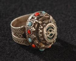 A Vintage, fancy ring with precious, colorful stones isolated on a black background photo