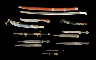 el conjunto de cuchillos y dagas antiguos aislados en un fondo negro, asia central, uzbekistán foto