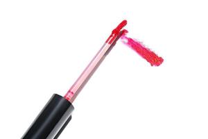 Smudge swatch of red matt lipstick gloss with sponge brush applicator on white backgeound. Make up cosmetics photo