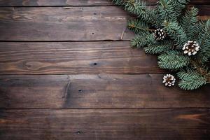 Christmas tree with cones on a dark wooden background. Copy space. Flat lay. photo