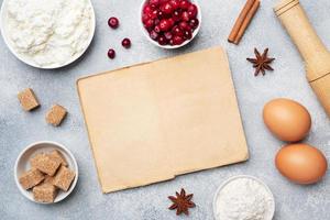 Ingredients for baking cookies, cupcakes and cake. Frame of Raw foods eggs flour sugar cottage cheese cranberries on a grey background with copy space. photo