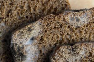 Black rye bread covered with black mold photo