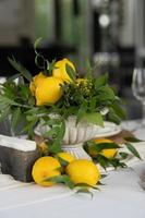 Festive table decorated with lemon arrangements photo