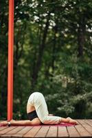 A young woman in doing yoga in the yard photo