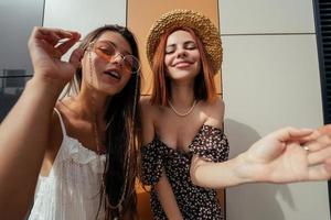 Two attractive young women fooling around in fresh air. photo