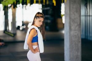 Healthy young female relaxed after training in gym. photo