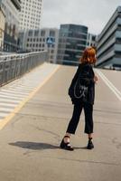 Young woman with a backpack on the road photo