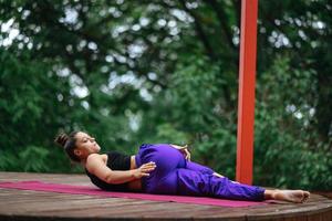 Young beautiful woman doing fitness exercises lying on her back photo