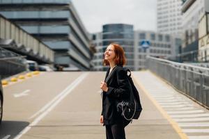 Young woman with a backpack on the road photo