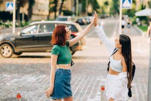 Two students high five to teach others after successful work together photo