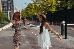 Happy meeting of two friends hugging in the street photo