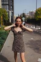 Young pretty trendy girl posing at the city in Europe photo