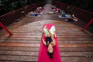 Group of young sporty people practicing yoga lesson with instructor, photo