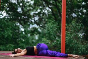 Young beautiful woman doing fitness exercises lying on her back