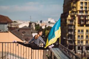 A young woman is doing twine on the roof of the house photo