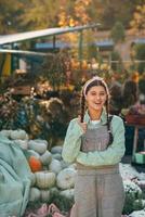 Farmer female poses for the camera in front of the counter. photo