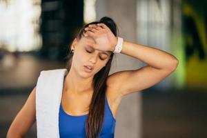 Healthy young female relaxed after training in gym. photo