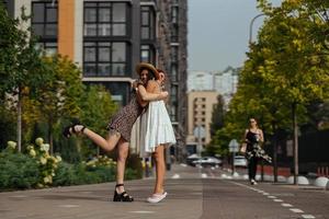 Happy meeting of two friends hugging in the street photo