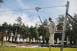 Woman wants to go bungee in the rope park photo