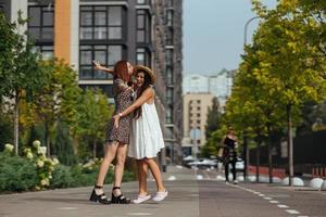 Happy meeting of two friends hugging in the street photo